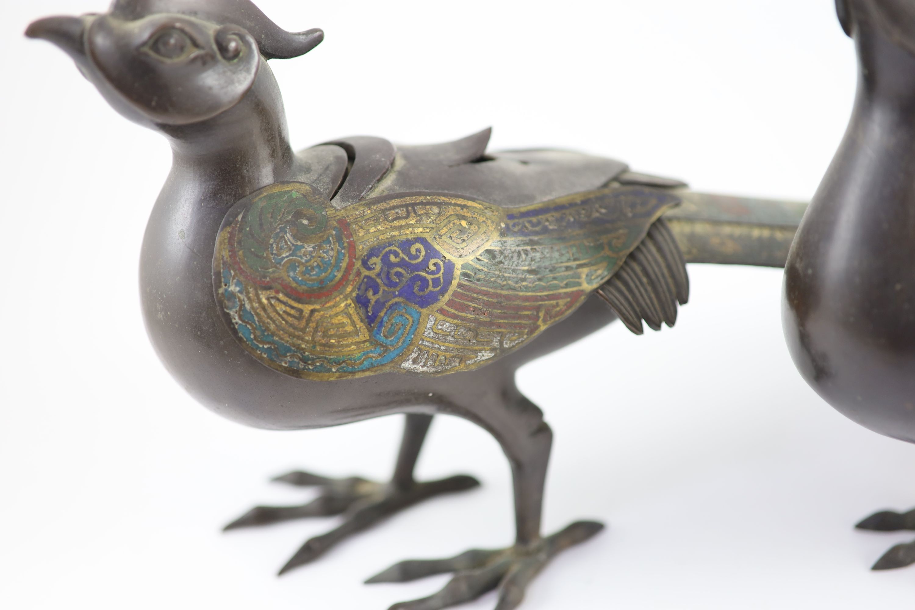 Two similar Japanese champlevé enamel and bronze ‘pheasant’ censers and covers, Meiji period, 39 cm long